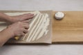 Hand cuts rolled dough into strips with knife. Process of making homemade pasta