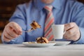 hand cutting homemade caramel custard cake on white plate. On wooden table Royalty Free Stock Photo