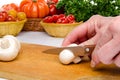 Hand cutting a mushroom Royalty Free Stock Photo
