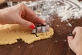 Hand Cutting Out Shapes from Rolled Out Ginger Cookies Dough wit Royalty Free Stock Photo