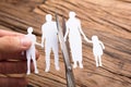 Hand Cutting Paper Family Over Wooden Table Royalty Free Stock Photo