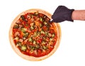 Hand cutting pizza with veggie vegetables, on bamboo bottom, isolate on white