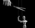 Hand cutting strings over puppet with scissors. Manipulation, negative influence, control stop concept. Overcoming