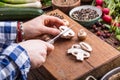 Hand cutting vegetables.Women hands is slicing mushrooms on wooden board near vegetables Royalty Free Stock Photo