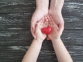 Hand dad and child heart red on black wooden Royalty Free Stock Photo