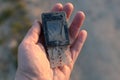 In hand damaged old phone - challenge with electronic waste recycling