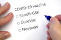 Hand daw in the questionnaire. Choice of vaccine: Sanofi-GSK, CureVac, Novavax. A closeup of female hand answering about a covid-