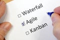 Hand daw in the questionnaire. A closeup of female hand answering about waterfall, agile, kanban question marking in a checkbox