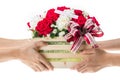 Hand delivers baskets of red and white rose flowers