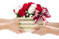 Hand delivers baskets of red and white rose flowers