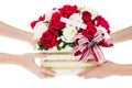 Hand delivers baskets of red and white rose flowers