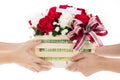 Hand delivers baskets of red and white rose flowers