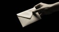 A hand delivers a private message envelope Royalty Free Stock Photo