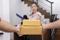 Hand of delivery man delivering package to homeowner. Woman accepting a delivery of boxes from deliveryman. Hand of Delivery man Royalty Free Stock Photo