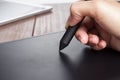Hand of the designer with pen on tablet Royalty Free Stock Photo