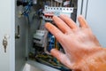 A hand in a dielectric glove opens the door to the electrical panel Royalty Free Stock Photo