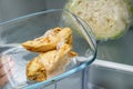 Hand of a dieting person holding taking cooked chicken brests in a glass container from a fridge Royalty Free Stock Photo