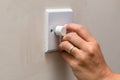 Hand dimming the lights to save on consumption