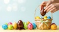 A hand dipping a chocolate Easter egg into a basket filled with colorful eggs Royalty Free Stock Photo