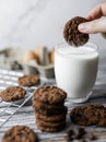 hand picked up a cookie from milk in glass Royalty Free Stock Photo