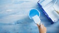 Hand Dips a brush in jar of blue paint Royalty Free Stock Photo