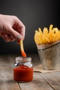 Hand dips French fries Royalty Free Stock Photo