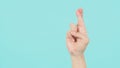 Hand is do goodluck hand sign and have foam soap bubbles on a green mint or Tiffany Blue isolated background Royalty Free Stock Photo