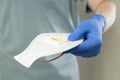 Hand in doctor gloves giving protective mask