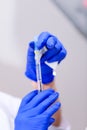 Hand of a doctor holding medical syringe during american pandemic. Medical syringe on hand of the doctor for corona virus treatmen Royalty Free Stock Photo