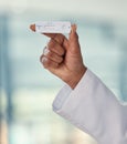 Hand of a doctor holding a negative covid test. African American doctor holding a corona virus test. Closeup of a caring