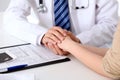 Hand of doctor reassuring her female patient. Medical ethics and trust concept Royalty Free Stock Photo