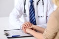 Hand of doctor reassuring her female patient. Medical ethics and trust concept Royalty Free Stock Photo