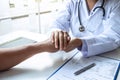 Hand of doctor touching patient reassuring for encouragement and empathy to support while medical examination on the hospital Royalty Free Stock Photo