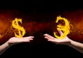 hand with dolar fire icon over and hand with euro fire icon over. Black and red (fire) background Royalty Free Stock Photo