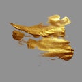 Hand drawing gold brush stroke paint spot on a gray background Royalty Free Stock Photo