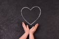 Hand drawing heart with chalk. Cute little girl with symbol of love. Royalty Free Stock Photo