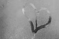 Hand drawing heart on the wet window glass Royalty Free Stock Photo