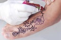 Hand drawing henna art on a foot with white background Royalty Free Stock Photo