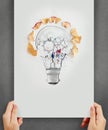 Hand drawing light bulb with pencil saw dust and gears icon Royalty Free Stock Photo