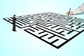 Hand drawing maze with thoughtful businessman standing in from Royalty Free Stock Photo