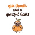 The hand-drawing quote: Give thanks with a grateful heart, with cute dog of pug breed in a pumpkin costume.