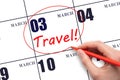 Hand drawing a red circle and writing the text TRAVEL on the calendar date 3 March. Travel planning.