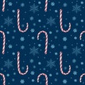 Hand drawn abstract Christmas seamless pattern with candy canes and snowflakes isolated on blue background Royalty Free Stock Photo