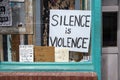 Hand-drawn anti-racist signs on display in the front window of a lounge in downtown Athens Georgia.