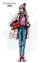 Hand drawn beautiful young woman with gift box. Stylish girl winter outfit. Fashion woman look. Royalty Free Stock Photo