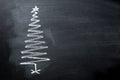 Hand Drawn Doodle Christmas Tree Chalk Blackboard in Spiral Form. New Year Greeting Card Poster Banner Royalty Free Stock Photo