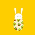 Hand drawn doodle cute kawaii white Easter bunny with funny face expression sitting on egg with floral pattern on yellow