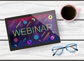 Hand drawn flat lay of a tablet, eyeglasses and a cup of coffee on white wooden table. Webinar