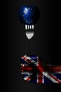 A hand with a drawn Great Britain flag holds a fork, on which is a ball with a drawn EU flag, a sign of influence, pressure, grip
