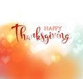 Hand drawn Happy Thanksgiving lettering on blurred background